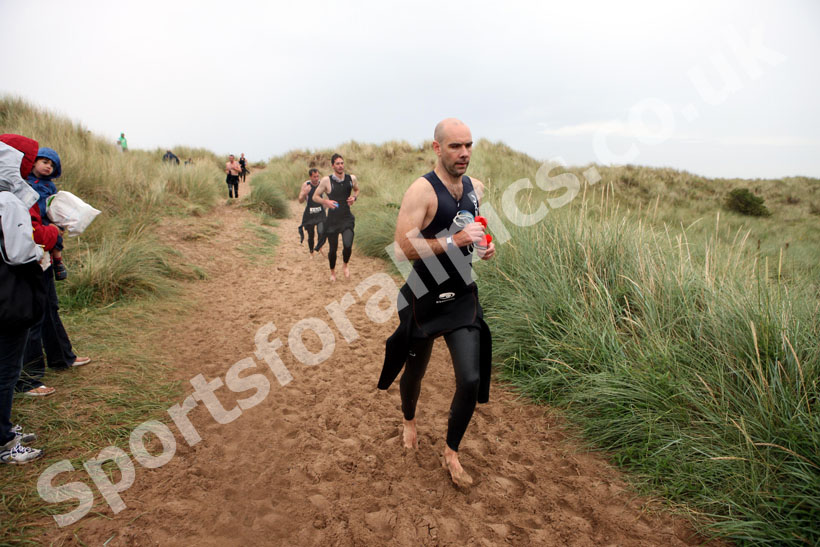 In transition from swimming to cycle during the Bamburgh Triathlon as the rain starts